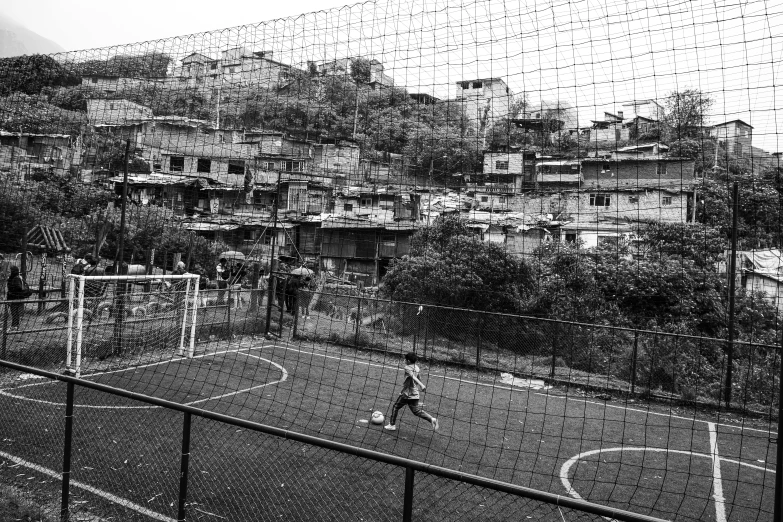 a person is playing soccer in the dark