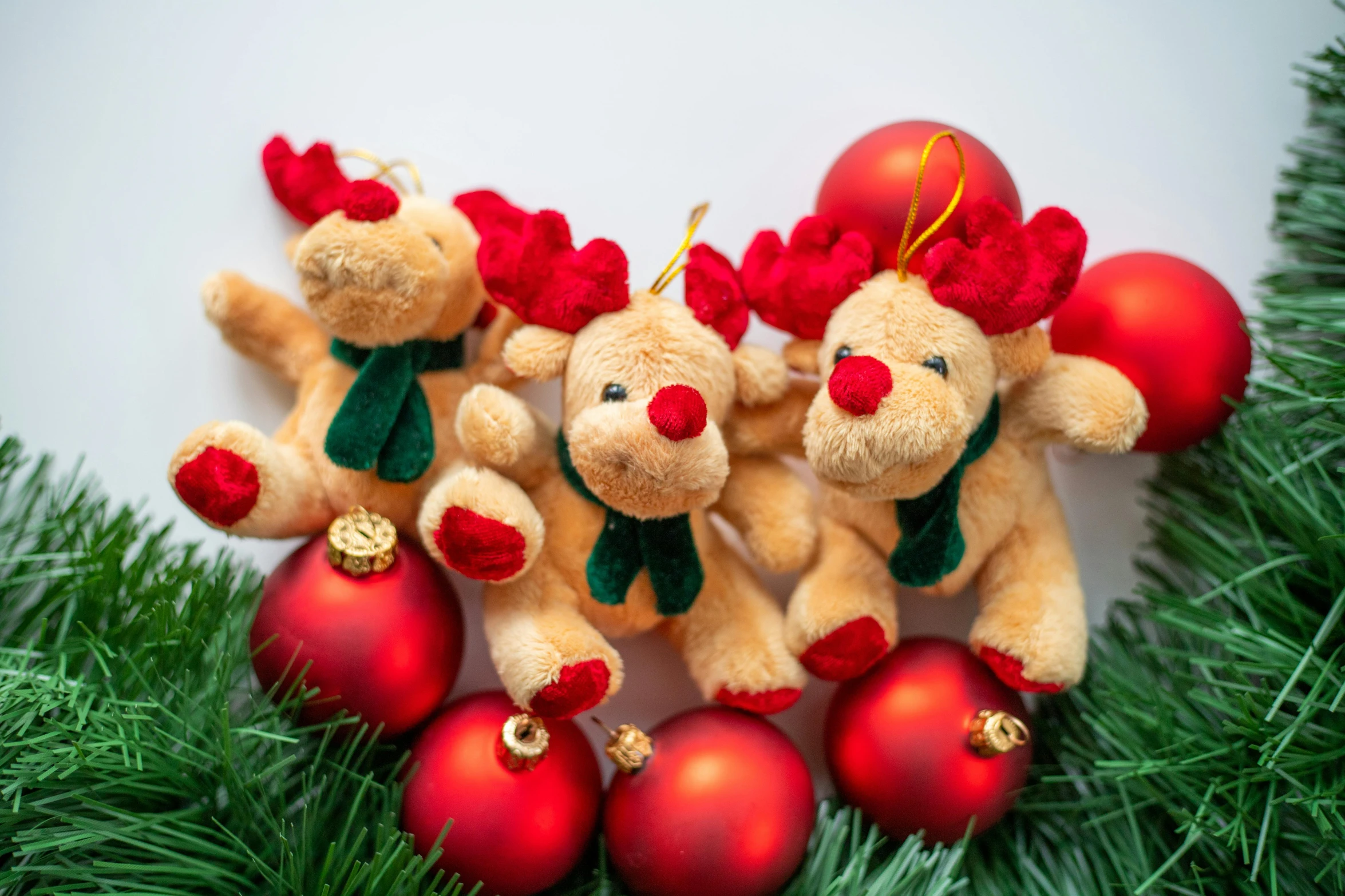 there are three teddy bears together on some christmas balls