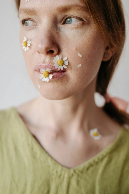 a woman with three white flowers in her nose