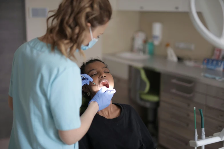 a woman is at a dentist with a toothbrush