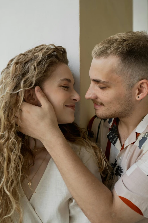 a man hugging a woman's face in an emce