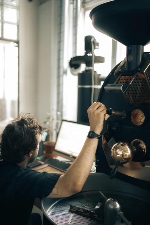 a person working on a machine with two laptops