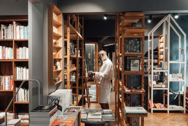 a person standing next to an open book case filled with books