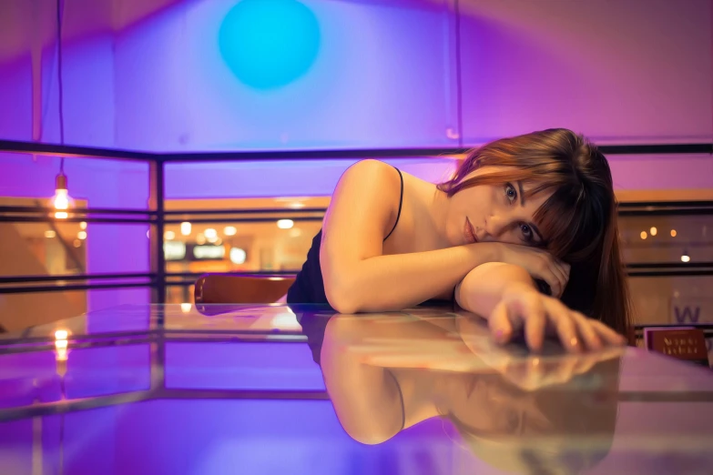 a woman is posing with her arms crossed near the glass