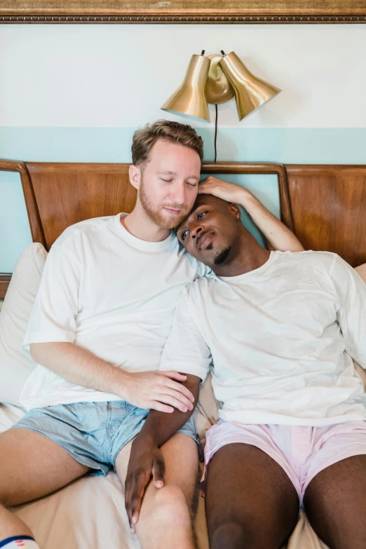 a man and woman cuddle together on the bed