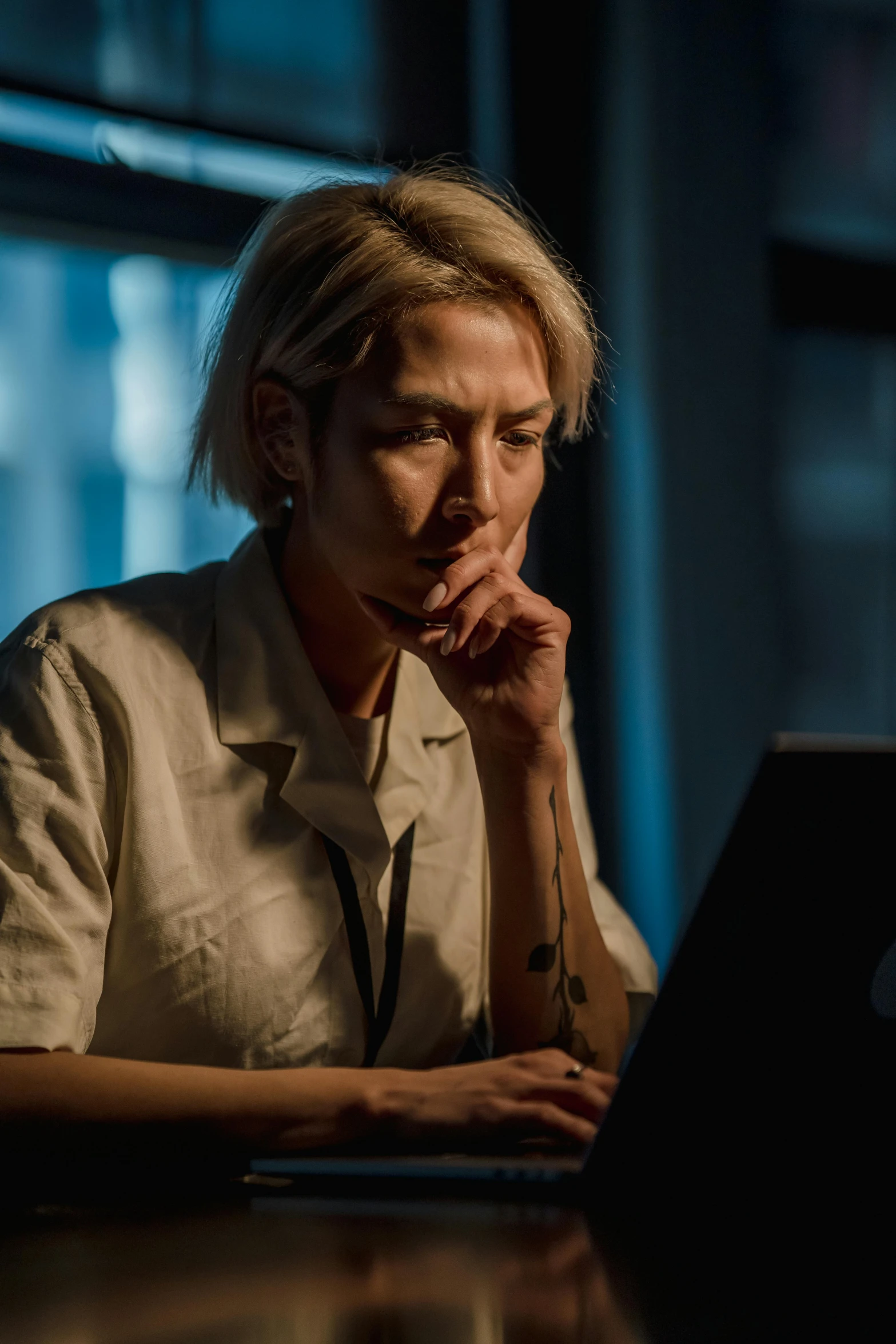 a man is looking at his laptop on a table