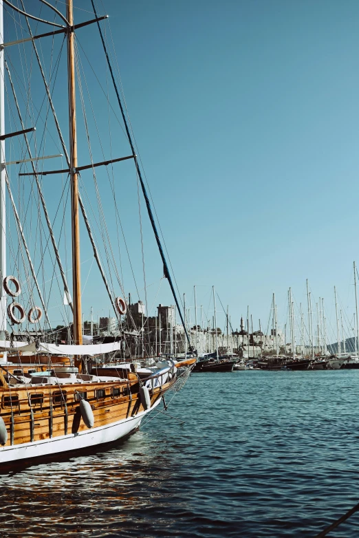 there is an old sailboat docked in the water