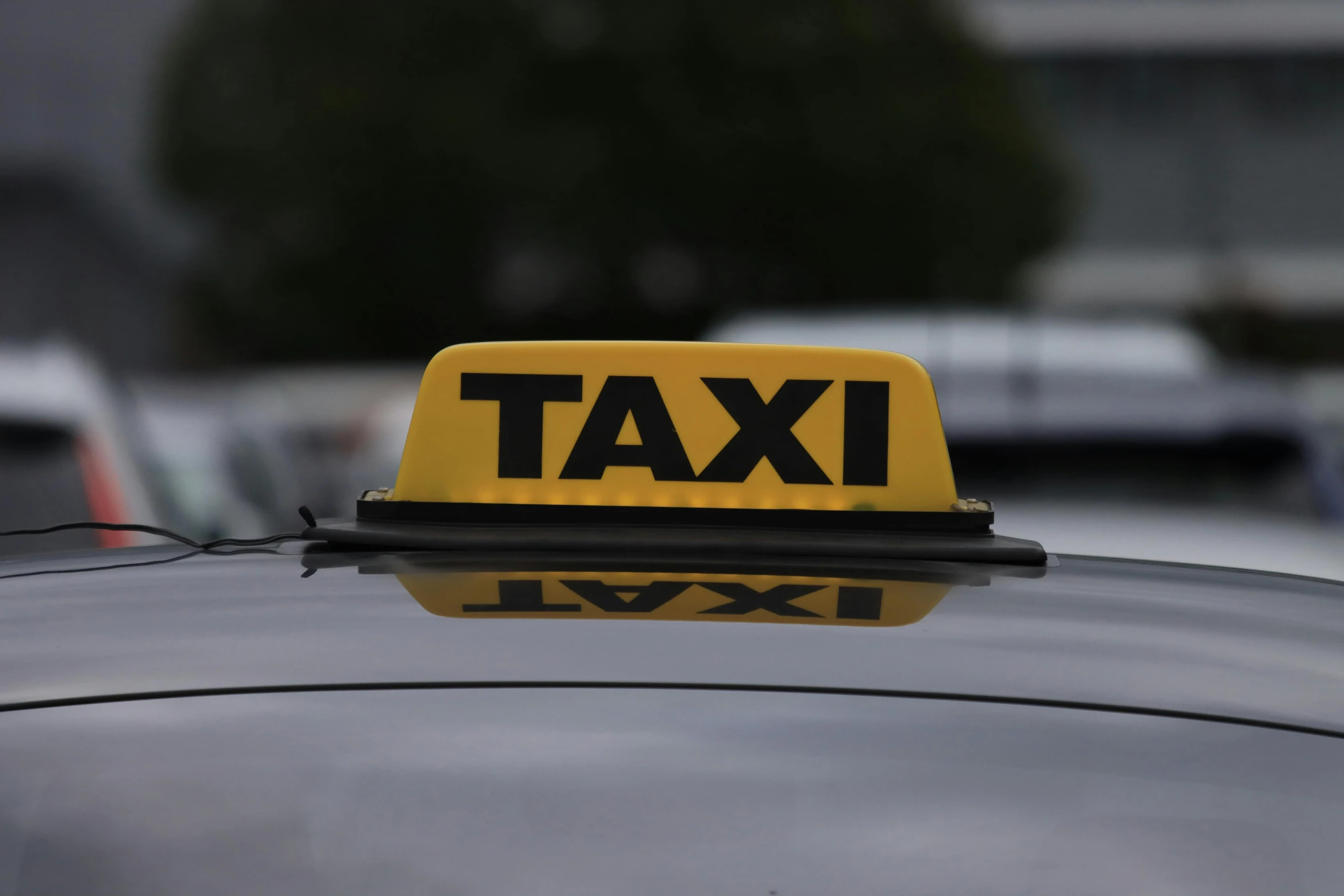 a taxi cab that is parked on the side of a road