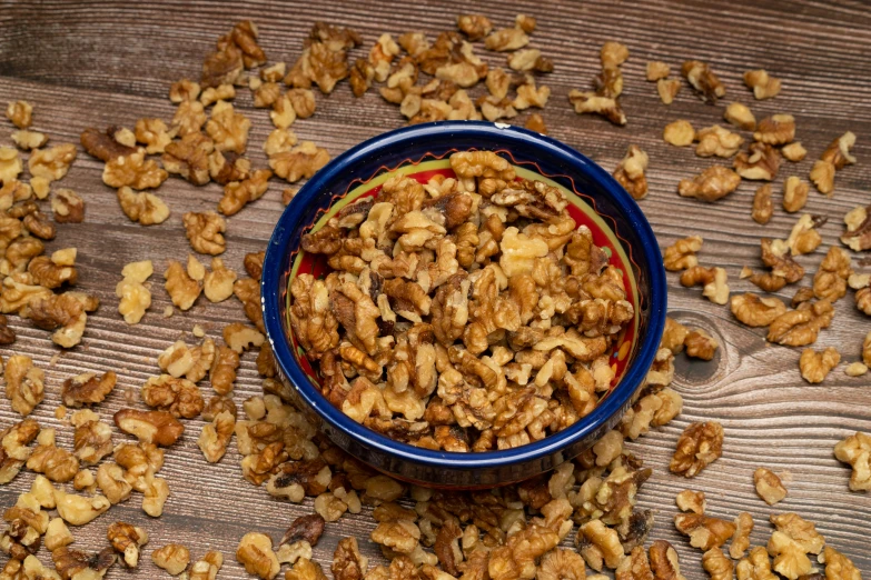 a bowl filled with granola sitting on a wooden table