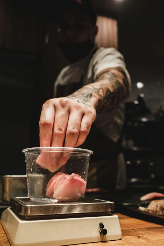 a man is preparing to eat food with sauce