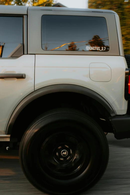 the large white truck is driving down the street