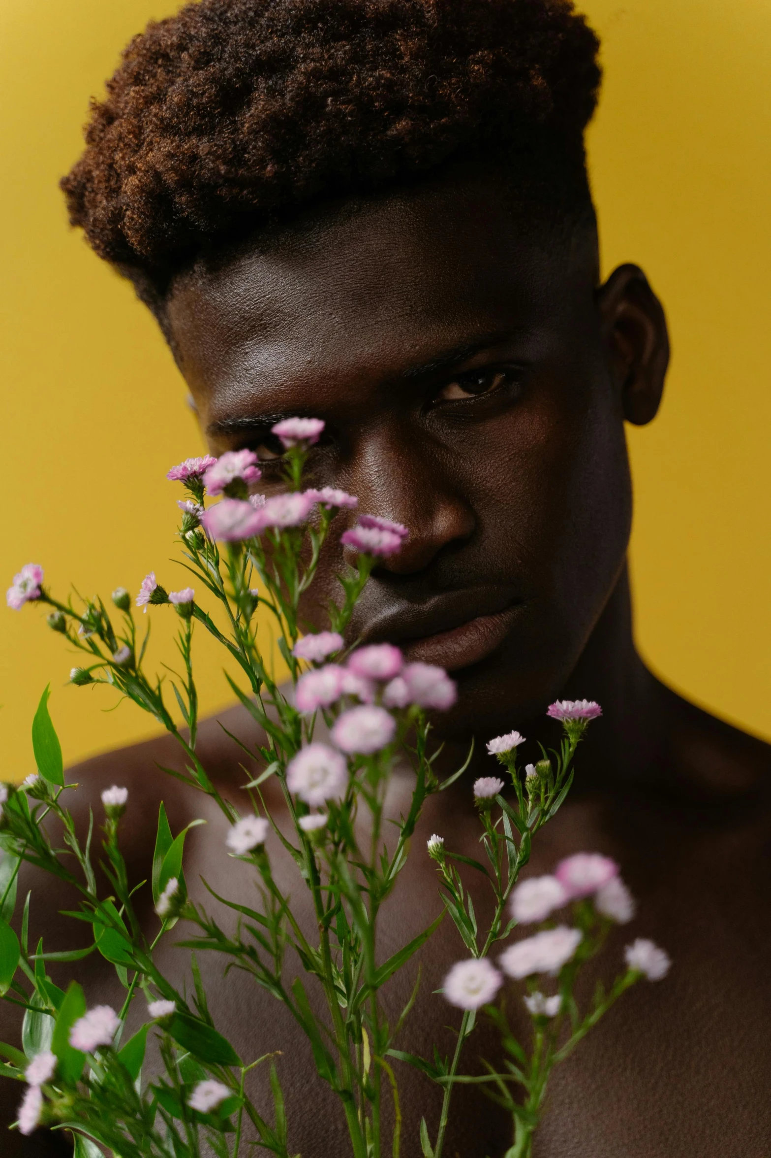 an image of man with flowers in front of him