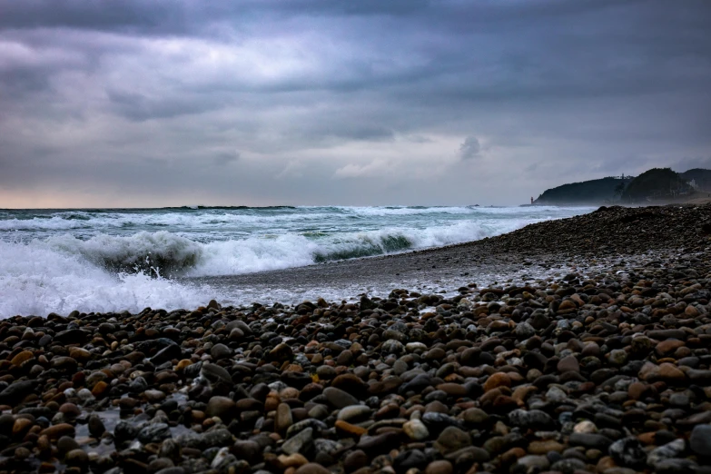 ocean water next to rocky beach with rock shoreline