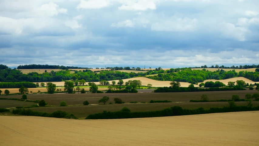 a view from a large hill of farm land