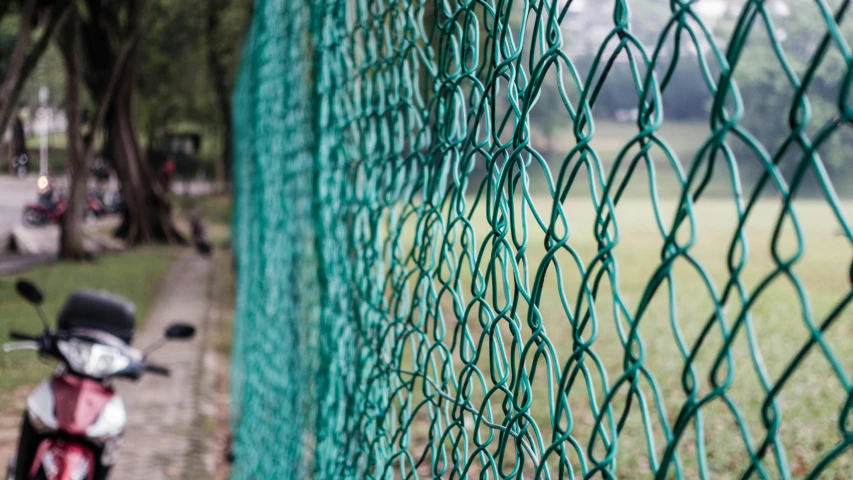 a close up view of the fence surrounding a bike