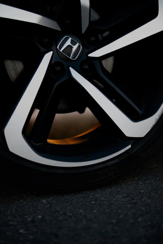 the wheels and rims of a car in the dark