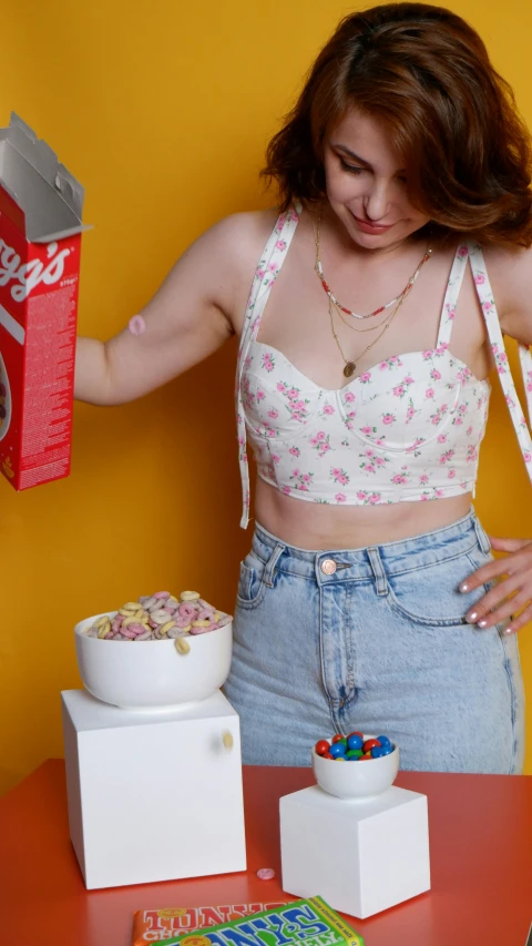 a woman with an unidentifiable package of cereal