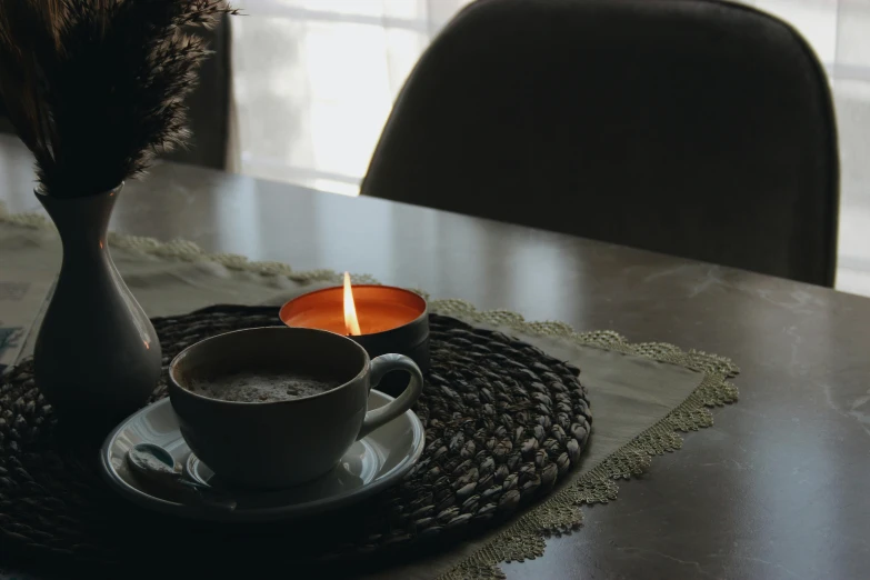 a table setting with candle and saucer