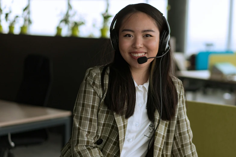 a girl is smiling and wearing headset