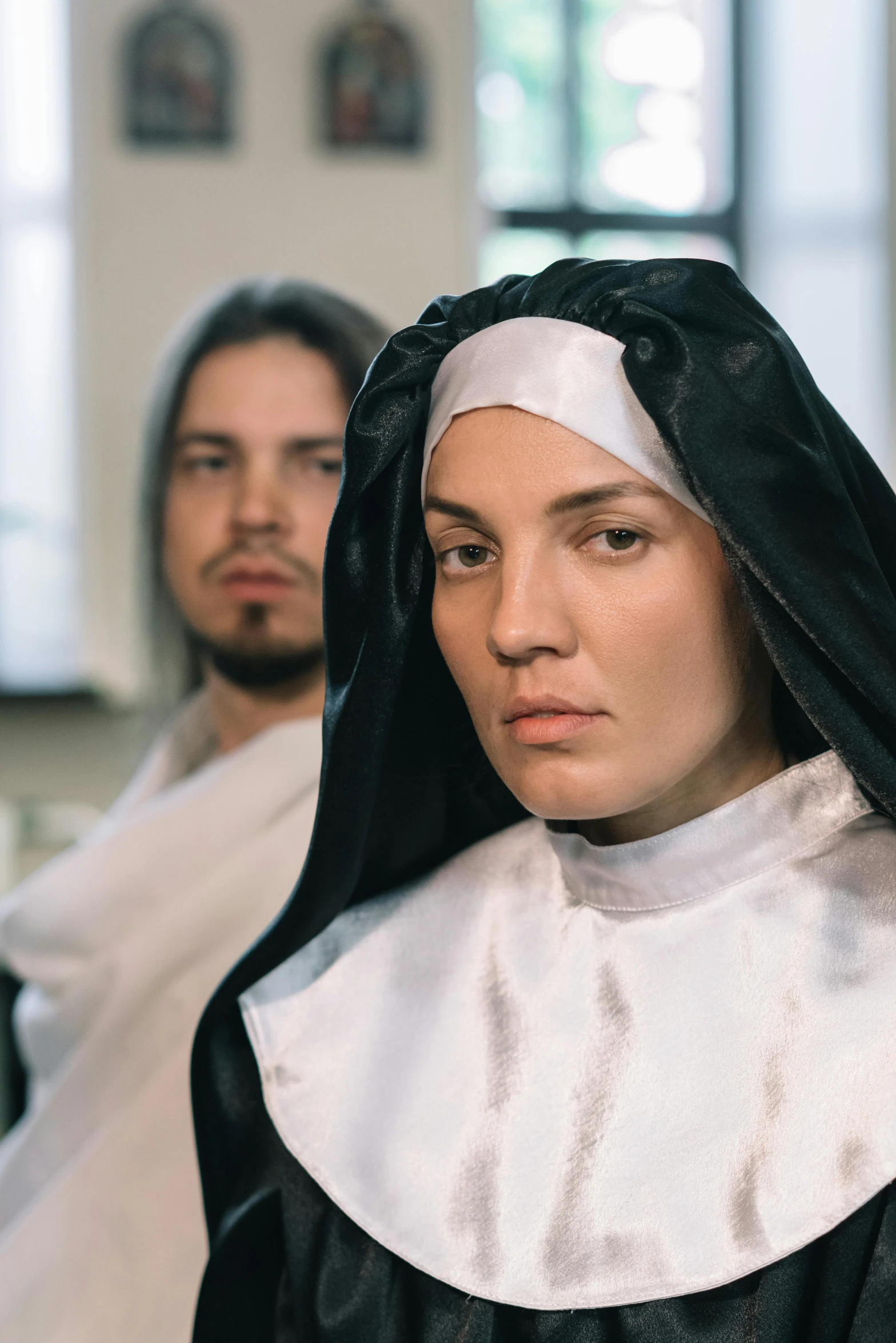 a nun and a man standing together in the room