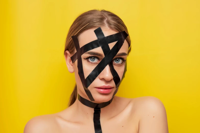 a girl has taped on her face with tape