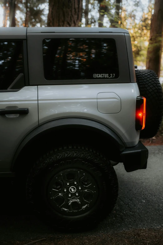 an suv parked in the driveway with trees