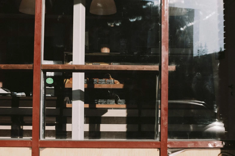 an empty wooden building with bottles in the window