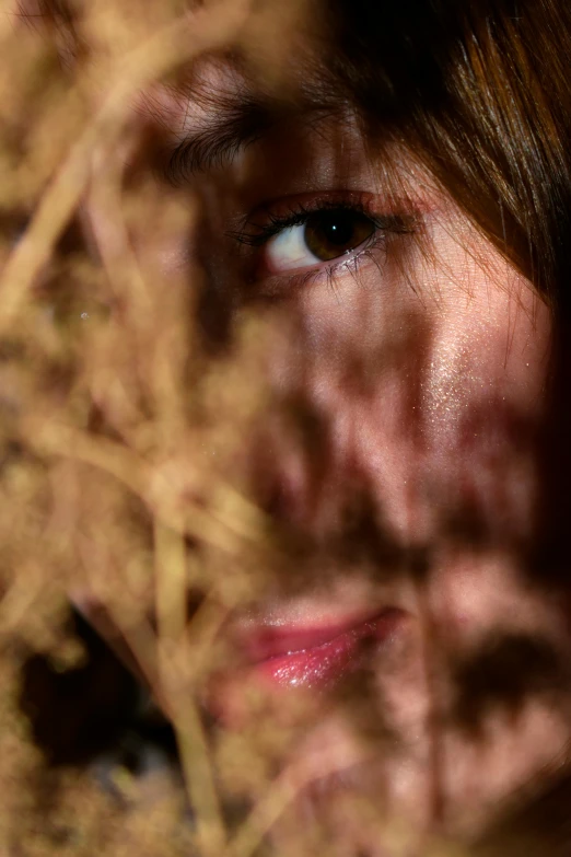 the reflection of a woman in the eyes is in the reflection of the grass behind her