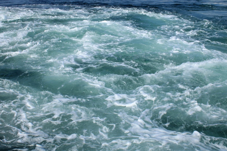 a view of waves in the ocean during daytime