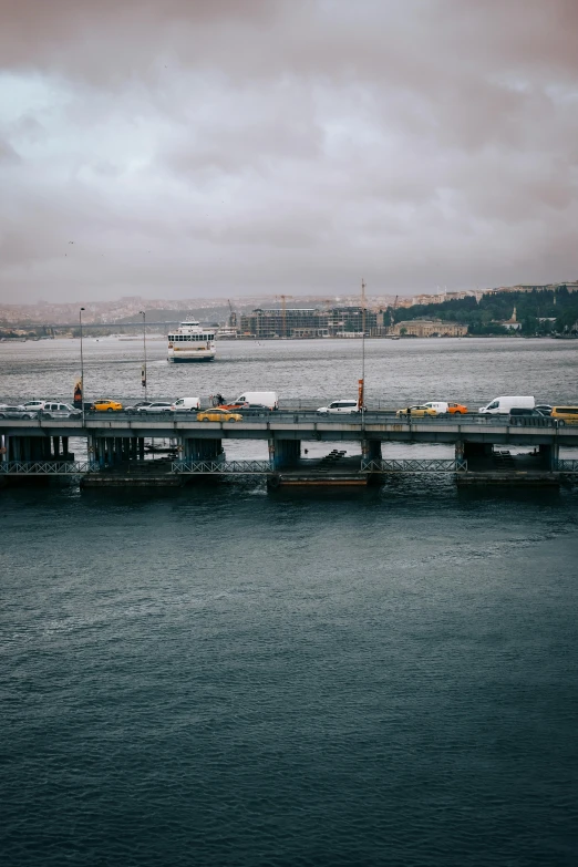 a large pier surrounded by the ocean on a cloudy day