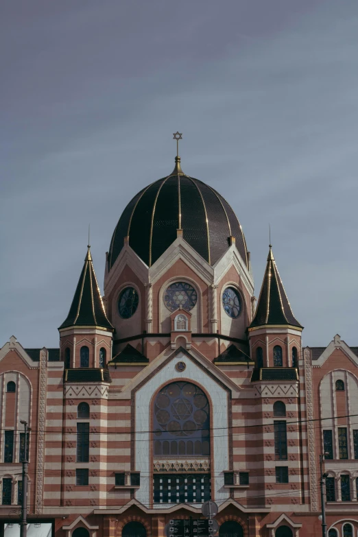 the roof of a building with clocks above it