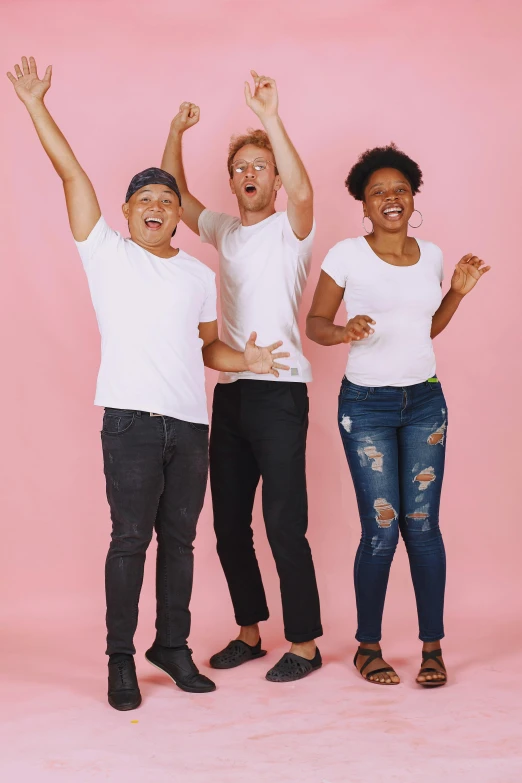 three people pose for a po in a studio