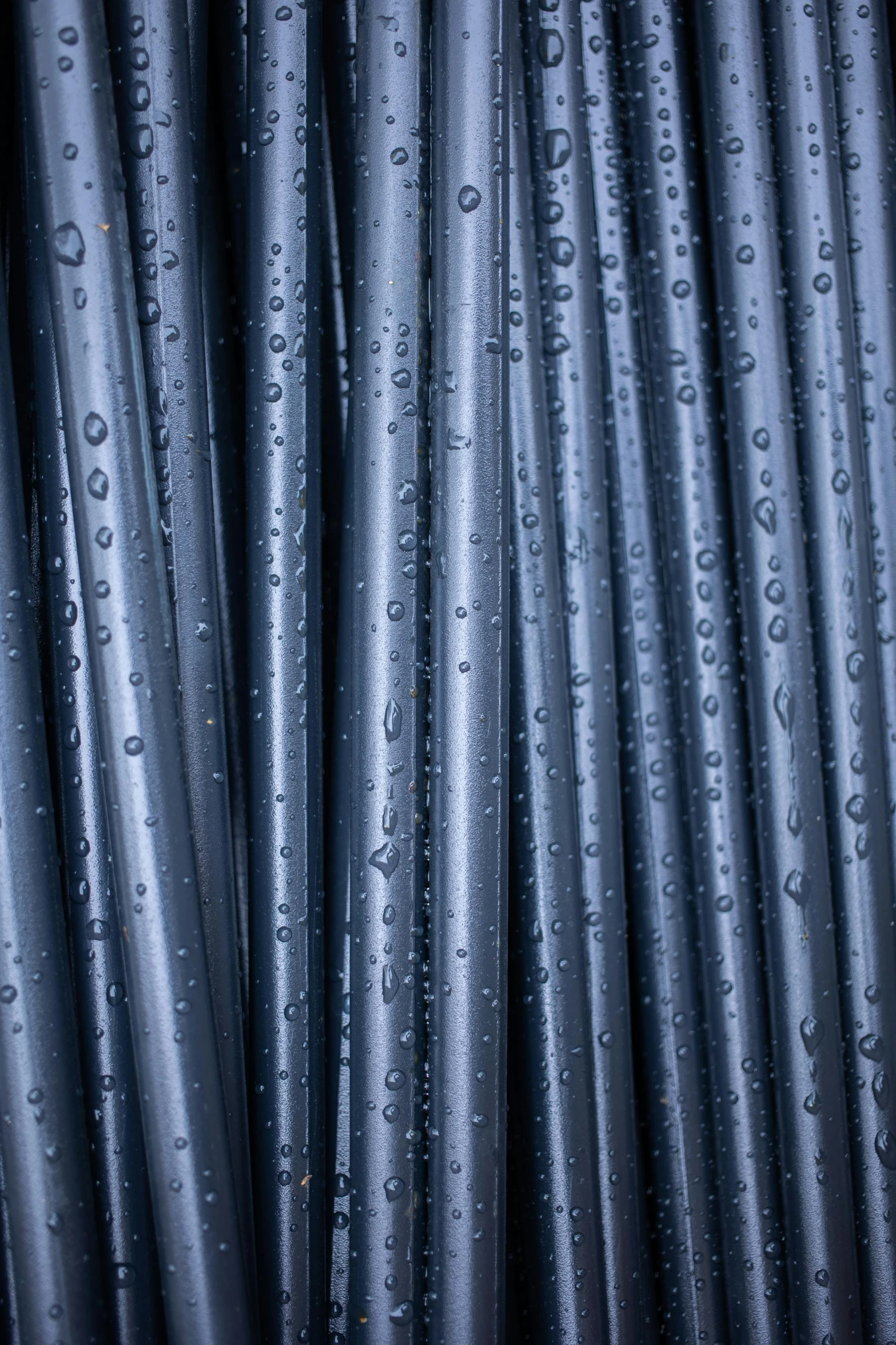 many water drops on the gray steel wire