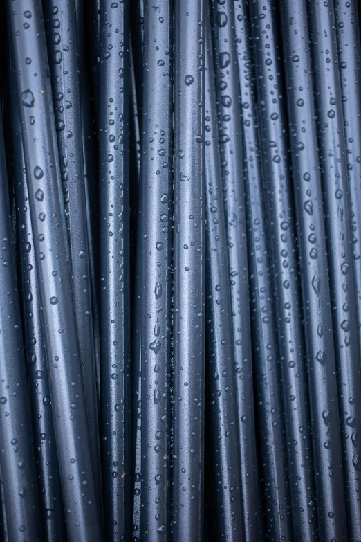 many water drops on the gray steel wire