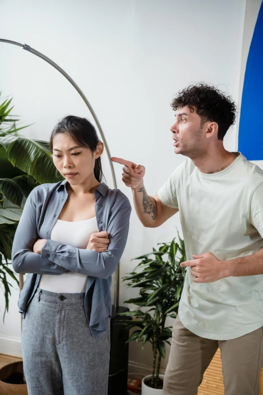 a woman is brushing a mans hair with scissors