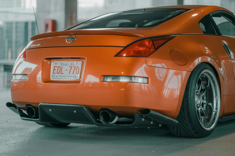 an orange sports car in a city garage