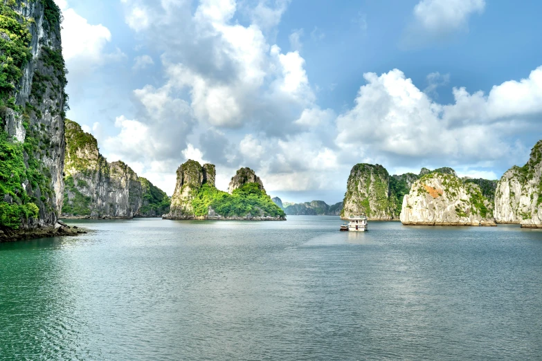 boats are out in the water near many green mountains