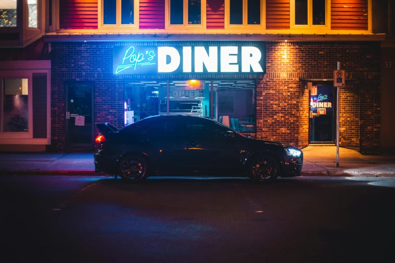 a parked car sits on the street under a neon sign