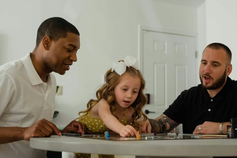 a father and daughter play games with their dad