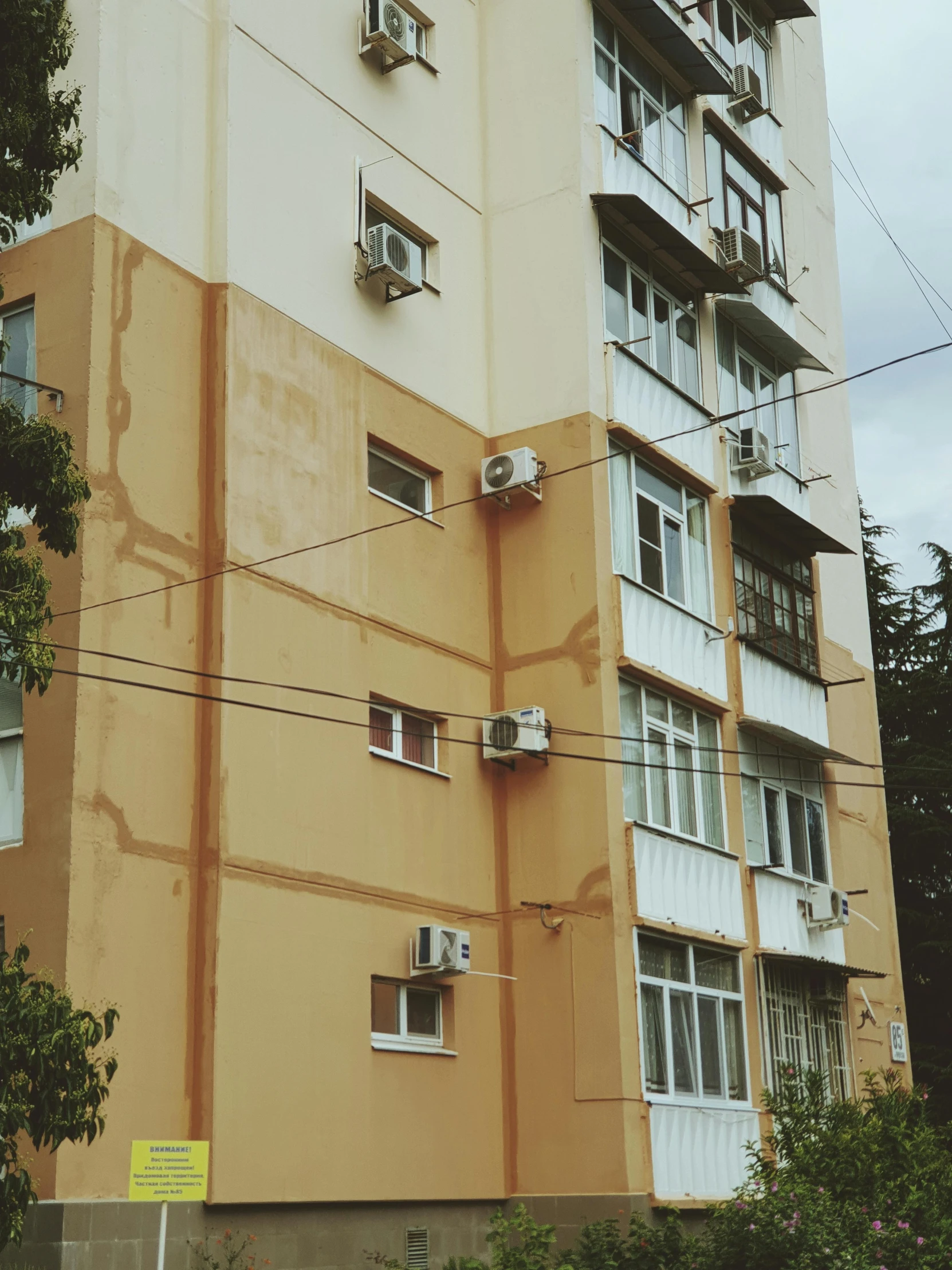 a multistory building next to an electric pole in front of it