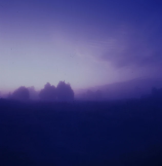 a person riding a horse in the dark under the clouds