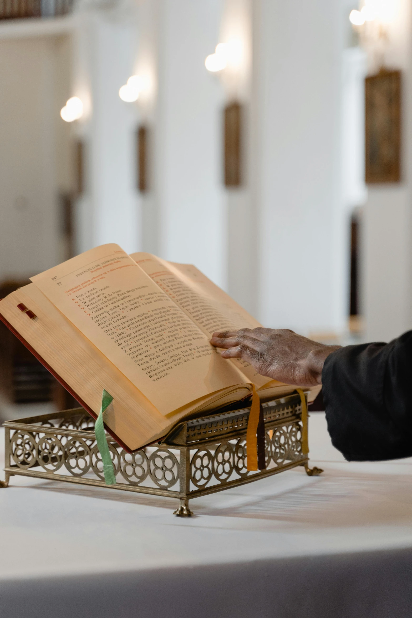 two hands holding the open book at the church