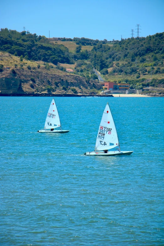 the two boats are floating on a lake