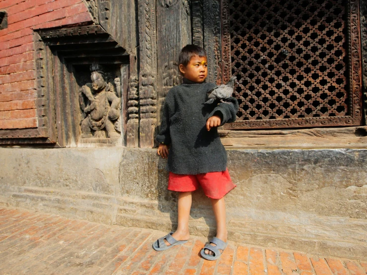 a  stands in front of an old brick building