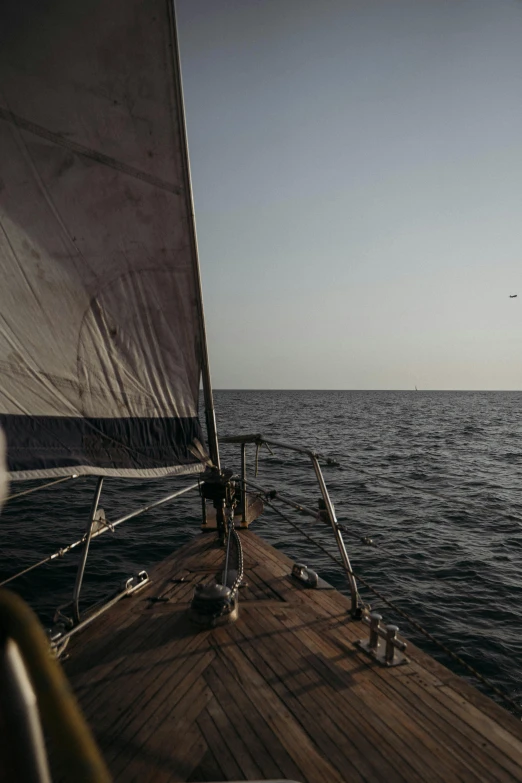 the sailboat on the water is sailing toward shore