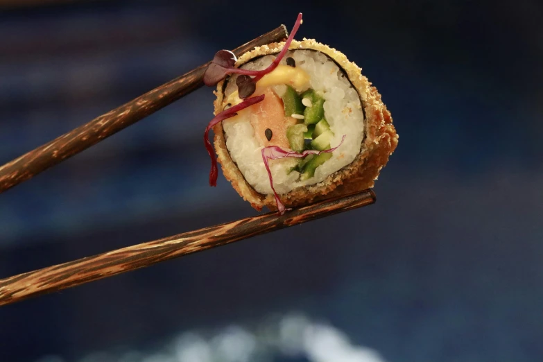 a close up view of a food item with chopsticks