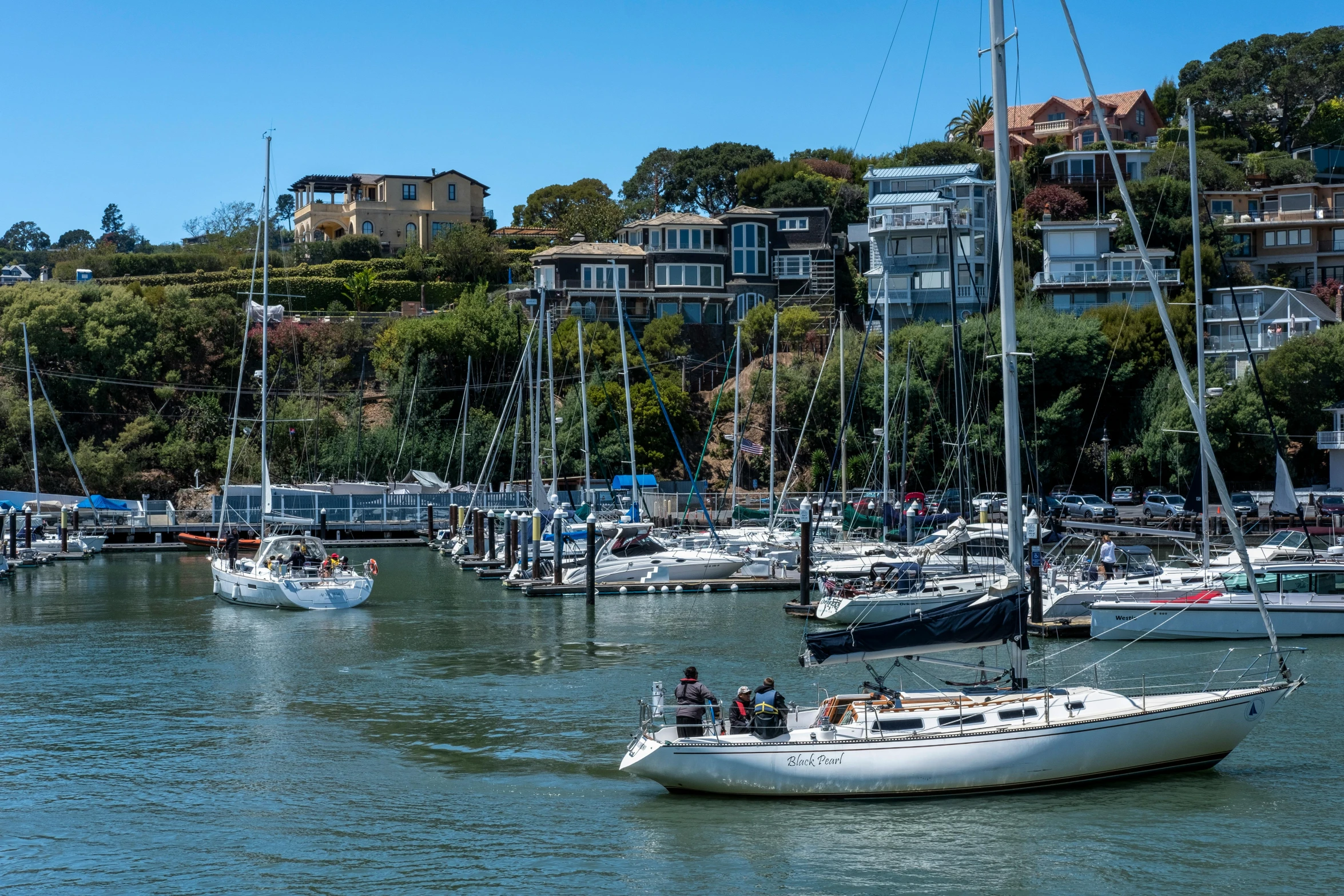 boats are parked at a marina and some buildings