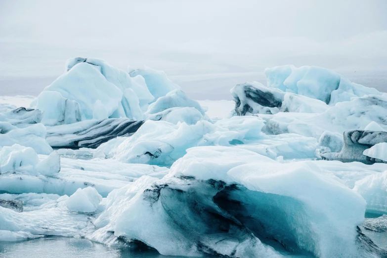 blue ice on water in open area with white rocks