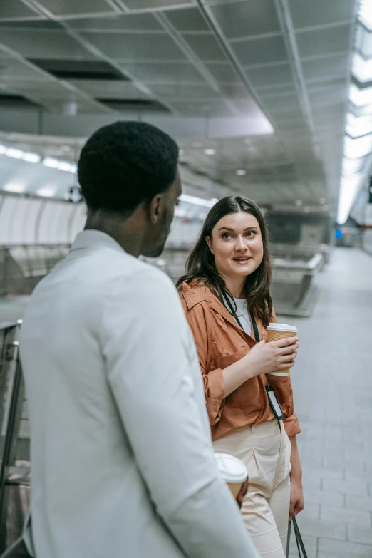 a woman and a man waiting at an airport