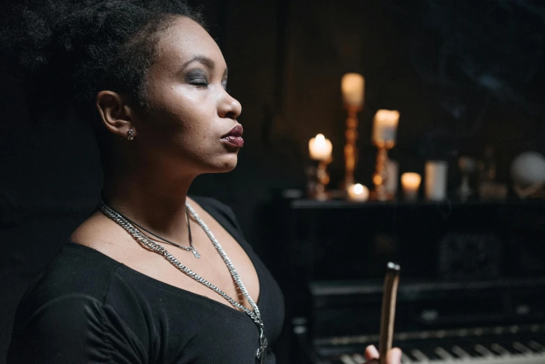 a black woman is holding an upright keyboard